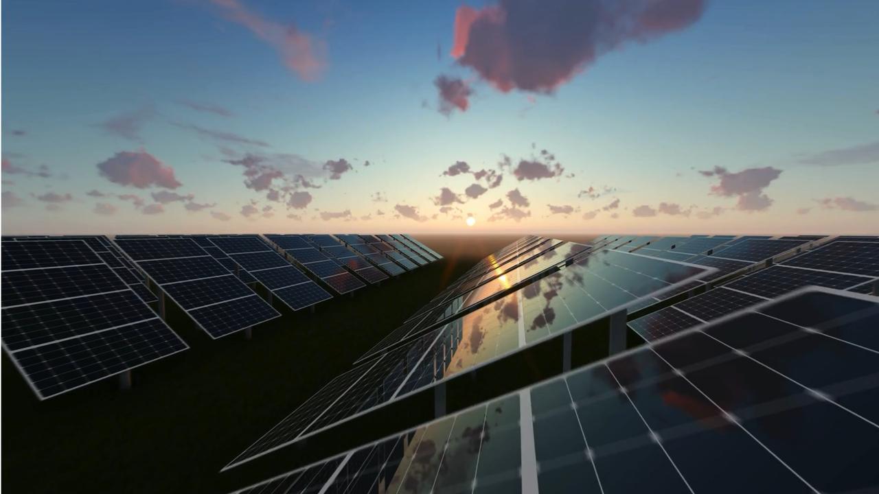 Rows of ground-mounted solar panels tilted toward a low sun at sunrise, the sky reflecting off the glass